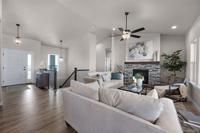 16990 Early Light Dr, Colorado Springs, CO 80908 - living room with dark wood-style flooring, a healthy amount of sunlight, lofted ceiling, and a fireplace