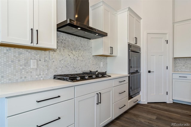 16990 Early Light Dr, Colorado Springs, CO 80908 - kitchen with wall chimney range hood, multiple ovens, white cabinets, tasteful backsplash, and black gas stovetop