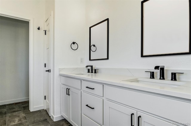 16990 Early Light Dr, Colorado Springs, CO 80908 - bathroom with double vanity, baseboards, and a sink