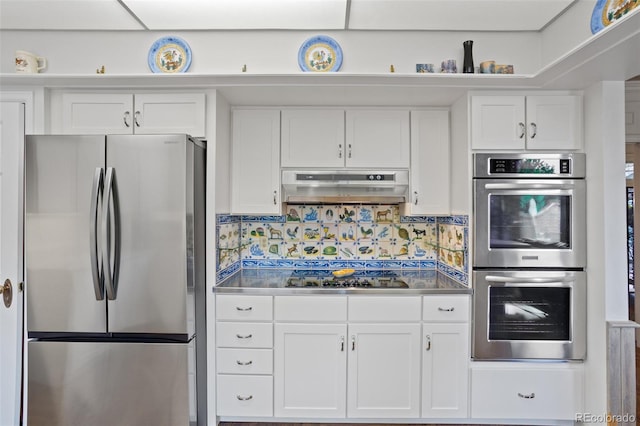 2800 S University Blvd Unit 1, Denver, CO 80210 - kitchen featuring appliances with stainless steel finishes, stainless steel countertops, white cabinets, under cabinet range hood, and tasteful backsplash