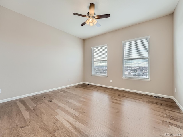 spare room featuring ceiling fan and light wood-type flooring