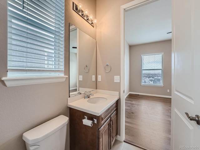 bathroom featuring vanity, toilet, and hardwood / wood-style floors