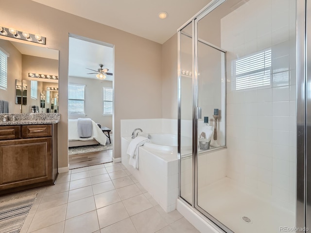 bathroom featuring tile patterned flooring, vanity, shower with separate bathtub, and ceiling fan