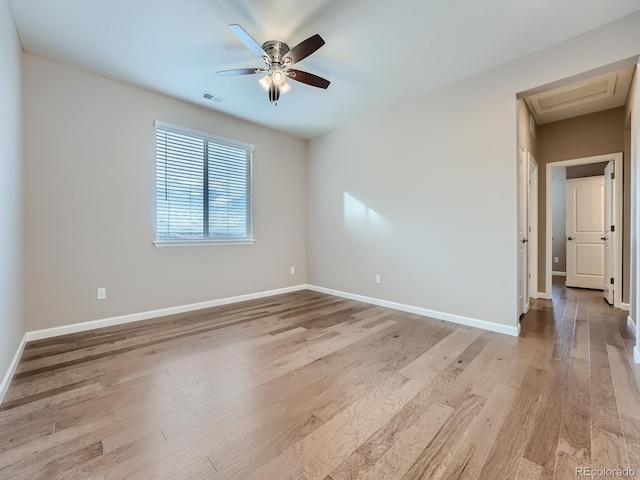 spare room featuring ceiling fan and light hardwood / wood-style flooring