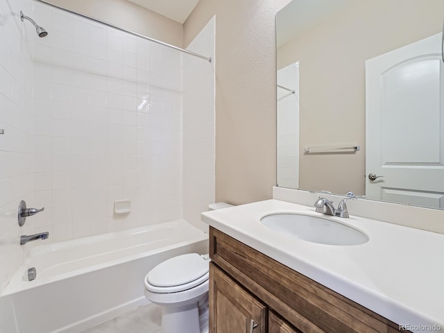full bathroom featuring tiled shower / bath combo, vanity, tile patterned flooring, and toilet