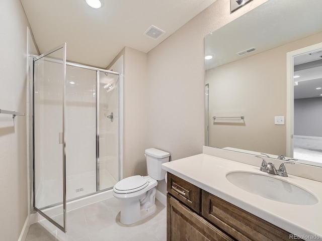 bathroom with vanity, a shower with shower door, tile patterned floors, and toilet