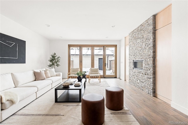 living room featuring light hardwood / wood-style flooring and a fireplace