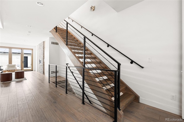 staircase with hardwood / wood-style flooring