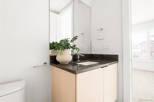 bathroom featuring toilet and vanity