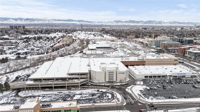 snowy aerial view with a mountain view