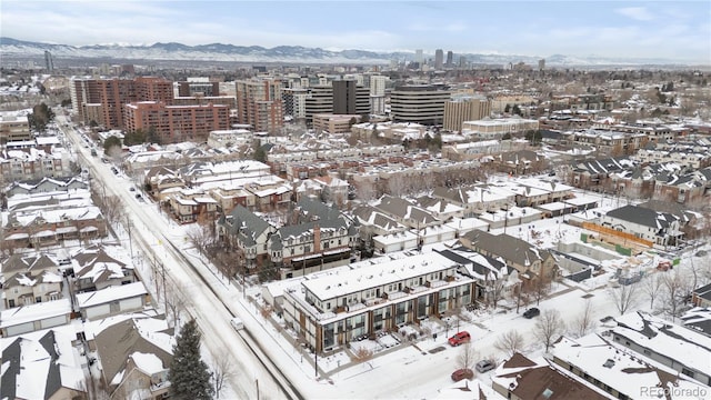 snowy aerial view featuring a mountain view