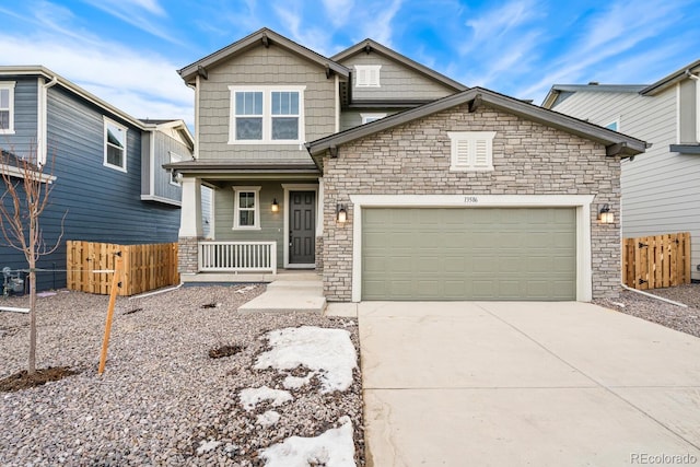 craftsman-style house with stone siding, concrete driveway, fence, a garage, and a porch