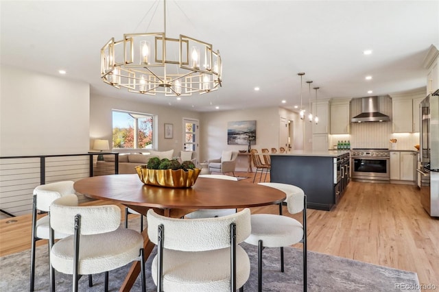 dining area featuring a notable chandelier and light hardwood / wood-style floors