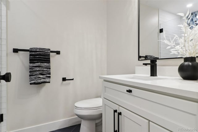 bathroom featuring tile patterned flooring, vanity, and toilet