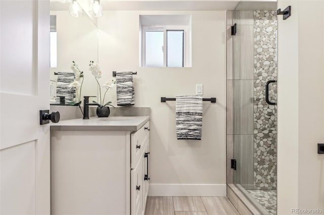 bathroom featuring vanity and a shower with shower door