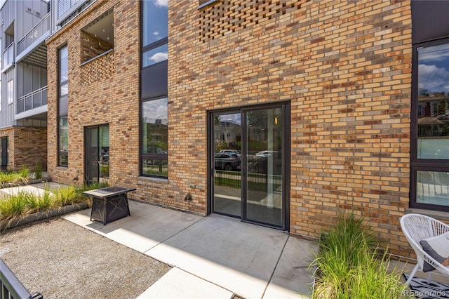 view of exterior entry with a patio