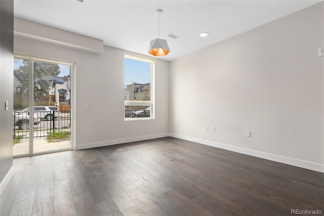 spare room featuring dark hardwood / wood-style floors