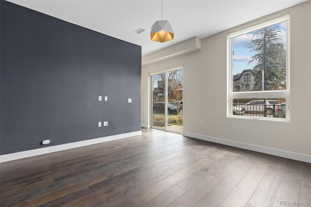 unfurnished room featuring hardwood / wood-style flooring