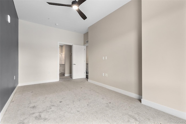 unfurnished bedroom with ceiling fan and light colored carpet