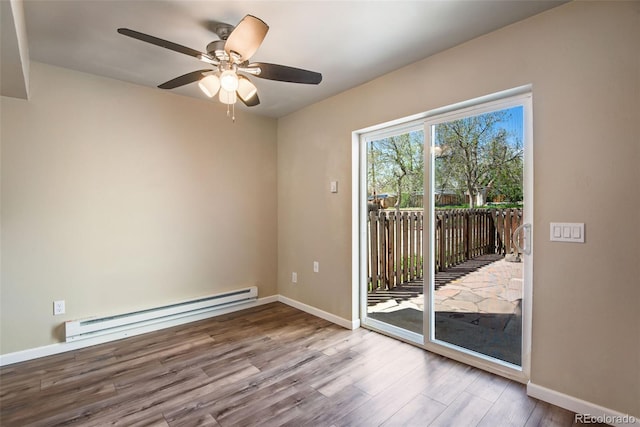 empty room with wood finished floors, baseboards, ceiling fan, and a baseboard heating unit