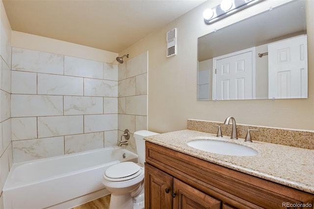 full bathroom featuring vanity, visible vents, wood finished floors, toilet, and shower / bath combination