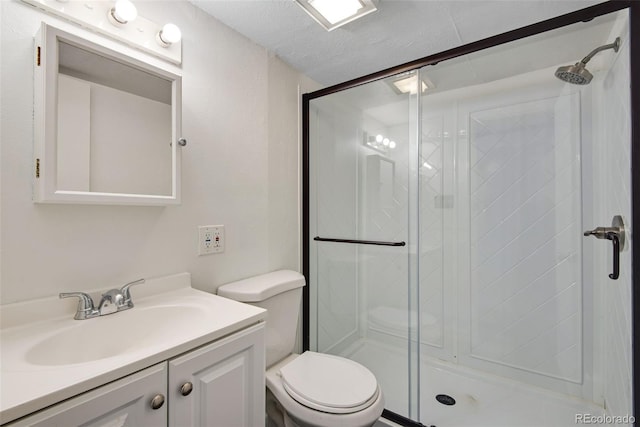 full bath featuring vanity, a stall shower, and toilet