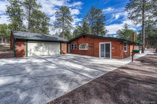 exterior space with an outbuilding and a garage