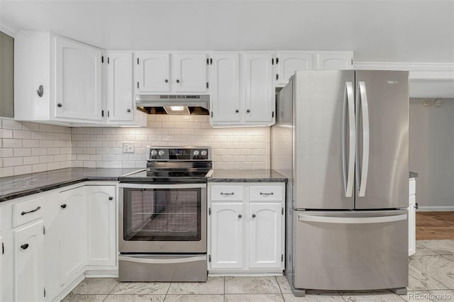 kitchen featuring decorative backsplash, appliances with stainless steel finishes, ventilation hood, dark stone countertops, and white cabinets