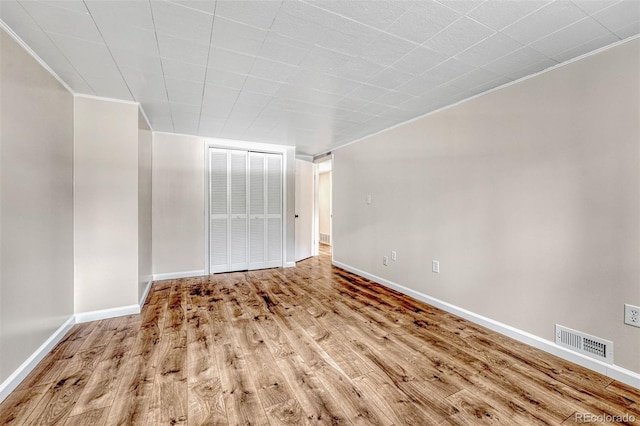 spare room with wood-type flooring