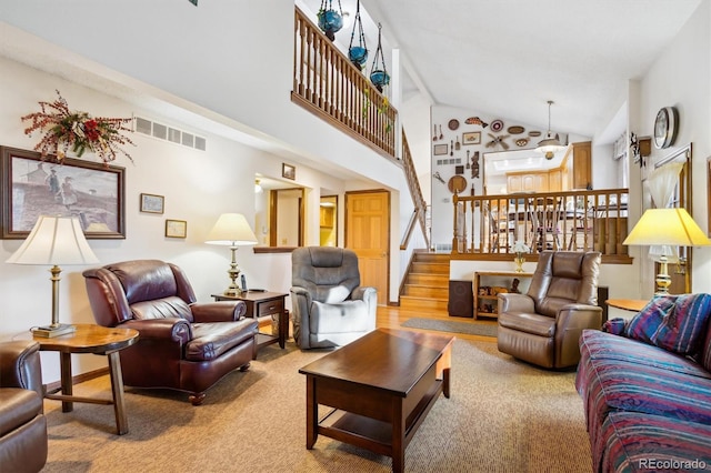2013 S Holland St, Lakewood, CO 80227 - living area featuring stairs, visible vents, carpet floors, and high vaulted ceiling