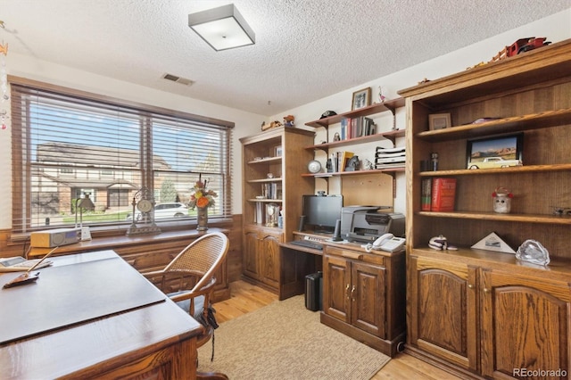2013 S Holland St, Lakewood, CO 80227 - home office featuring light wood-style floors, visible vents, and a textured ceiling