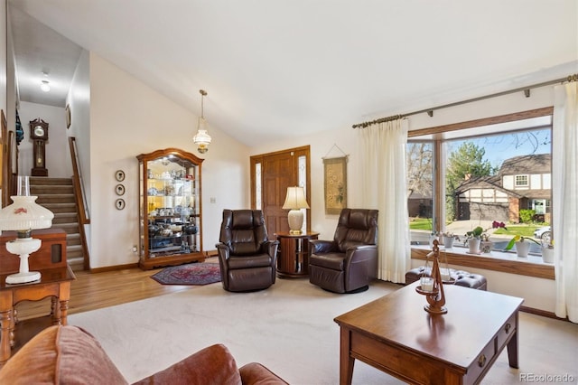 2013 S Holland St, Lakewood, CO 80227 - living area with lofted ceiling, stairs, baseboards, and wood finished floors