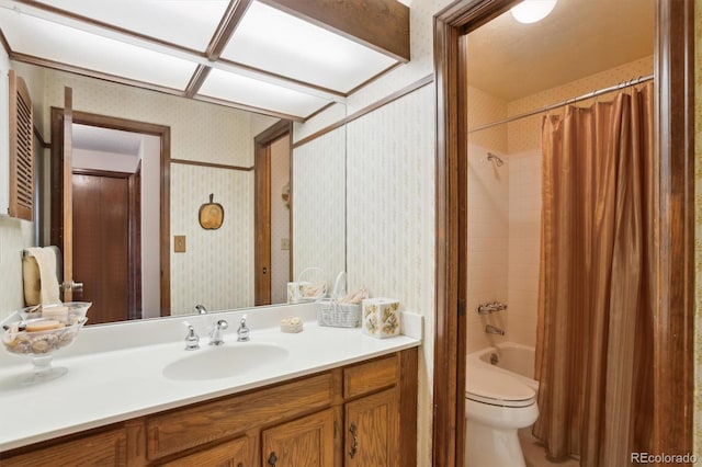 2013 S Holland St, Lakewood, CO 80227 - full bathroom featuring vanity, toilet, wallpapered walls, and shower / bath combo