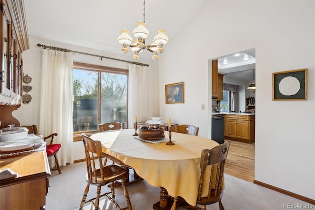 2013 S Holland St, Lakewood, CO 80227 - dining room with an inviting chandelier, light carpet, baseboards, and lofted ceiling