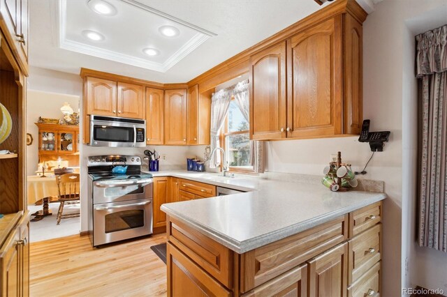 2013 S Holland St, Lakewood, CO 80227 - kitchen featuring recessed lighting, crown molding, light wood-style floors, light countertops, and appliances with stainless steel finishes