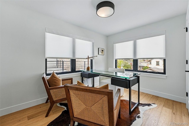 office featuring baseboards and light wood-type flooring