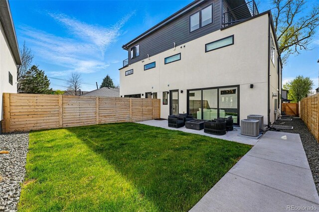 back of house featuring an outdoor living space, a patio, stucco siding, and central AC