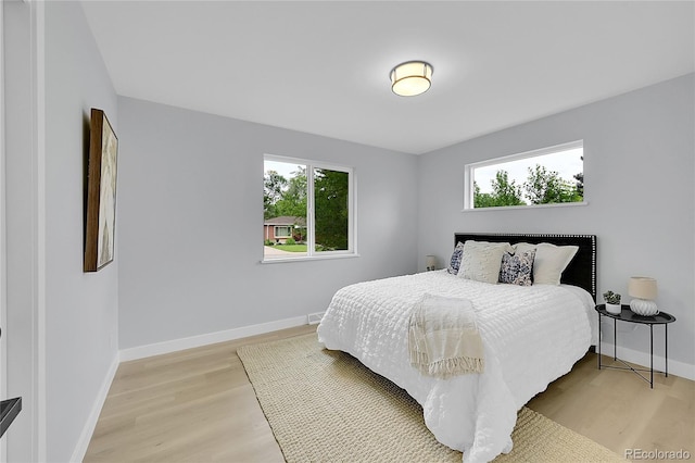 6526 S Elmwood St, Littleton, CO 80120 - bedroom with light wood-style flooring, multiple windows, and baseboards