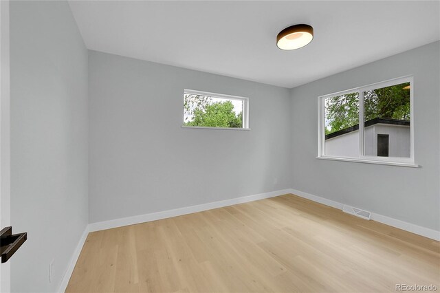 6526 S Elmwood St, Littleton, CO 80120 - spare room featuring wood finished floors, healthy amount of natural light, and baseboards