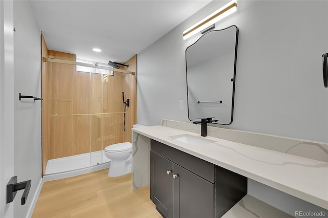 6526 S Elmwood St, Littleton, CO 80120 - full bathroom with vanity, a shower stall, toilet, wood finished floors, and recessed lighting