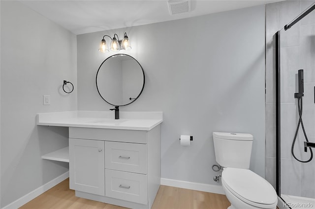 6526 S Elmwood St, Littleton, CO 80120 - bathroom featuring wood finished floors, toilet, vanity, and a shower stall