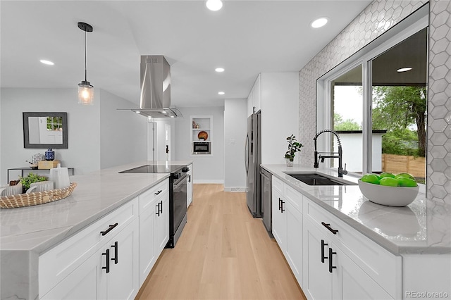 6526 S Elmwood St, Littleton, CO 80120 - kitchen with island exhaust hood, appliances with stainless steel finishes, light wood-style flooring, light stone countertops, and recessed lighting