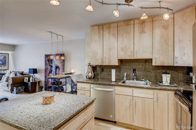 kitchen featuring sink, stainless steel dishwasher, and light brown cabinetry