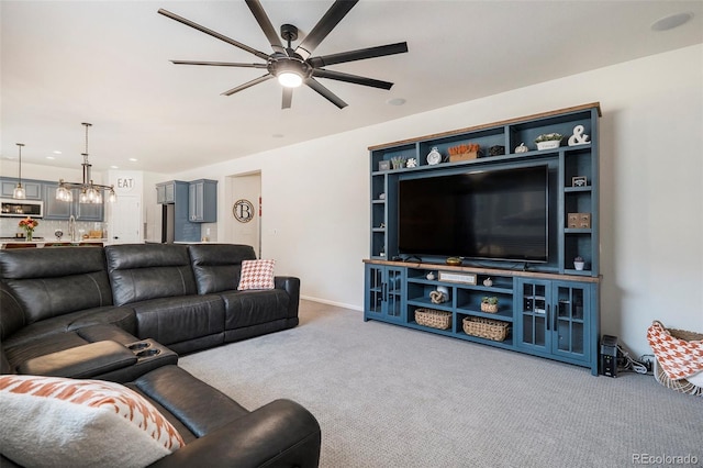 carpeted living room featuring ceiling fan