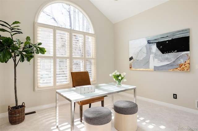 office area featuring vaulted ceiling and light colored carpet