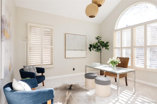 carpeted home office featuring lofted ceiling