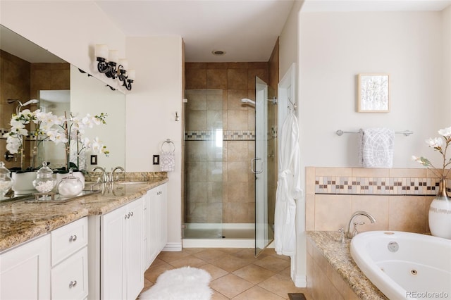 bathroom with plus walk in shower, tile patterned flooring, and vanity