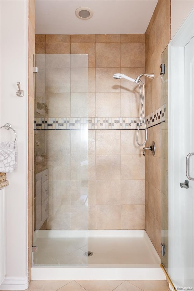 bathroom featuring a shower with door