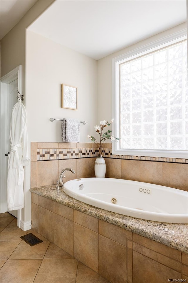 bathroom featuring tiled bath and tile patterned floors