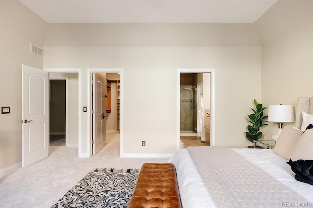 bedroom featuring light carpet and connected bathroom